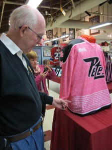 Peter Pearson of the PDSHOF points to the names of his parents on the 2016 Pink in the Rink sweater